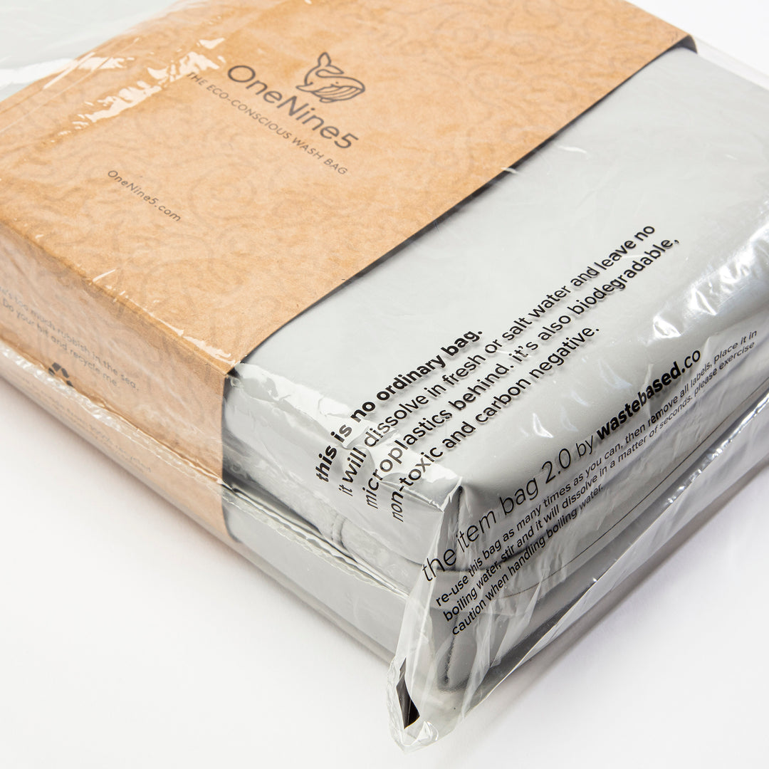 A Moeraki Grey OneNine5 wash bag packed inside a clear Aquapak polybag