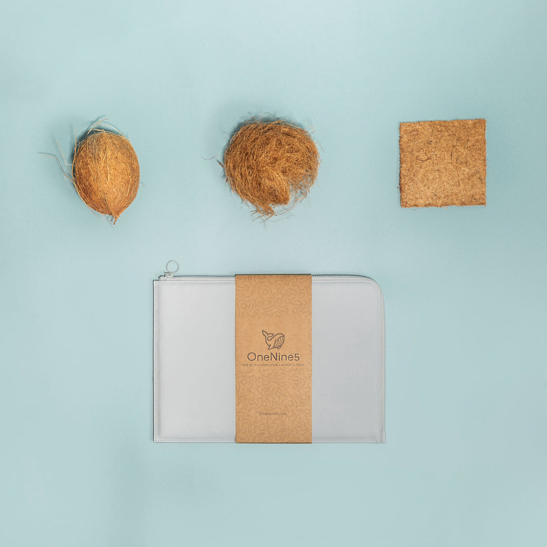 A birdseye view of the OneNine5 Moeraki Grey Laptop Sleeve, on a soft blue background. Above is example of the coconut coir fibre used for padding inside