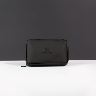 A front on view of the Miho Black Eco Essentials Pouch. Placed on a white surface with a black background. The debossed OneNine5 logo is visible centrally on the front of the pouch.