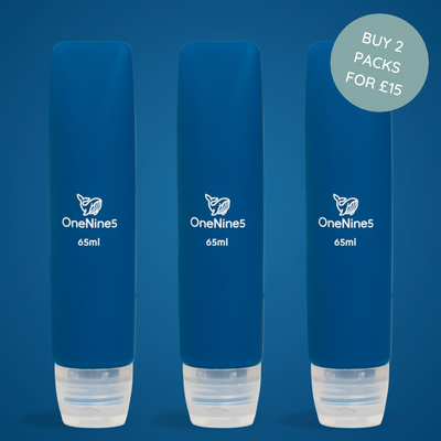 Three blue OneNine5 silicone travel bottles on a matching blue background. A white OneNine5 logo is visible on the front of the bottles that states a volume of 65ml.