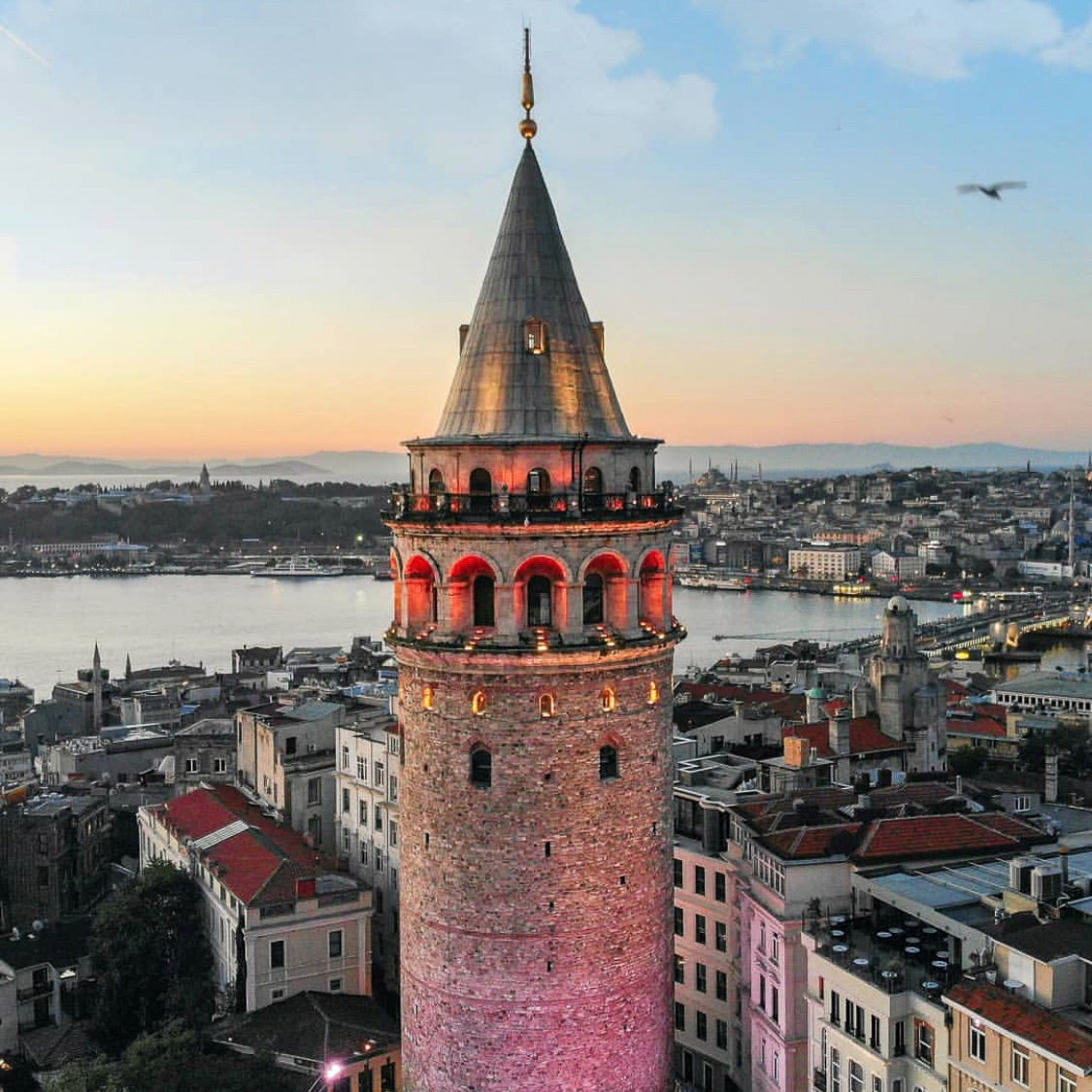 Sunrise over the Galata Tower in Istanbul. In the background is the Golden Horn and The Blue Mosque