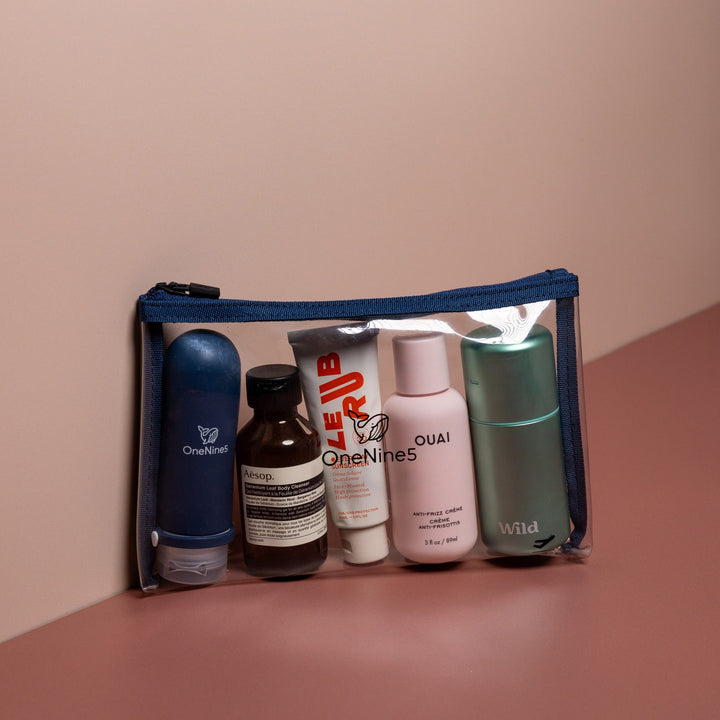 Blue clear liquid travel bag filled with toiletries including bottles and cosmetics for organised airport security packing