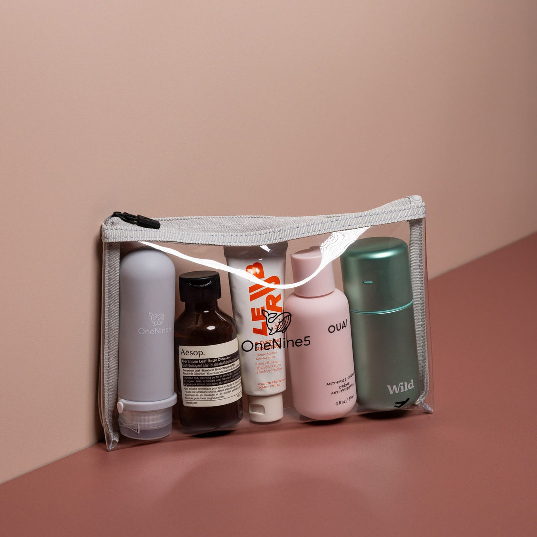 Grey clear liquid travel bag filled with toiletries and travel-size bottles for organised airport security use