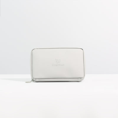 A front on view of the Moeraki Grey Eco Essentials Pouch. Placed on a white surface with a grey background. The debossed OneNine5 logo is visible centrally on the front of the pouch.